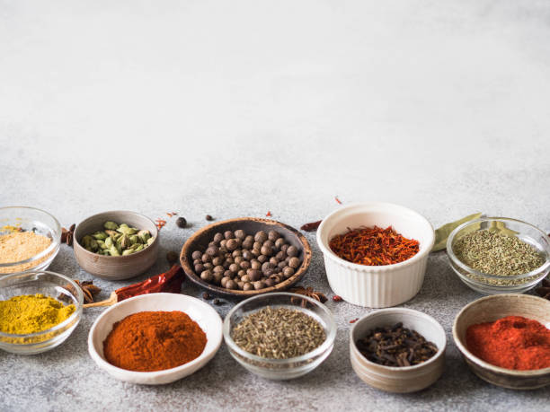 istock Various dry spices in small bowls on gray background. copy space 1139303296