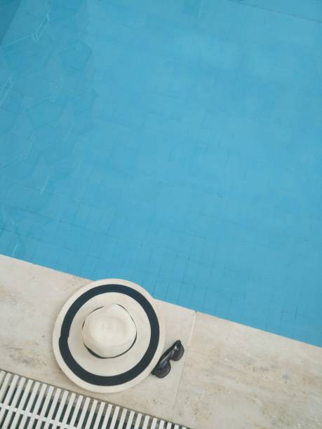 istock Straw hat with sunglasses near the pool 1139304933