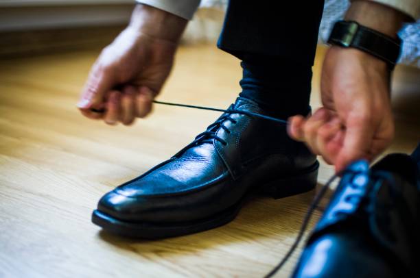 istock Man lace up shoe in his wedding day 1139305056