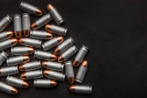 istock cartridges for a pistol on a black background. Flat lay copyspace 1139307216