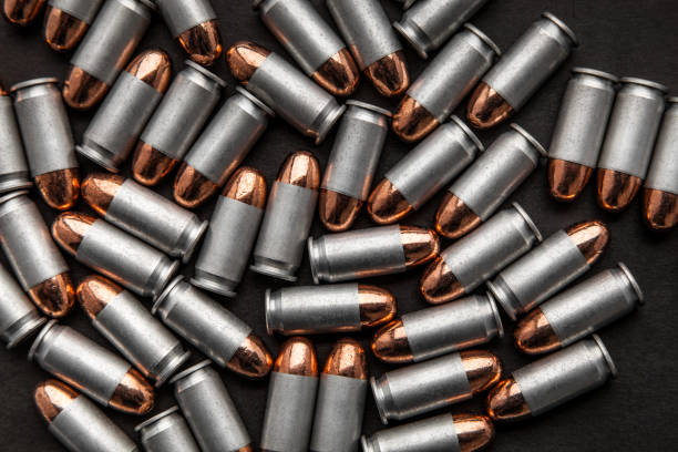 istock cartridges for a pistol on a black background. Flat lay copyspace 1139307765