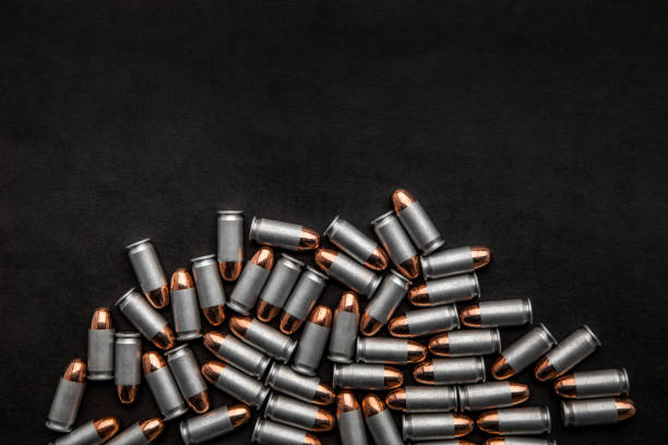 istock cartridges for a pistol on a black background. Flat lay copyspace 1139307790