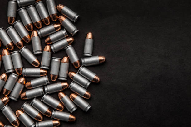 istock cartridges for a pistol on a black background. Flat lay copyspace 1139307796