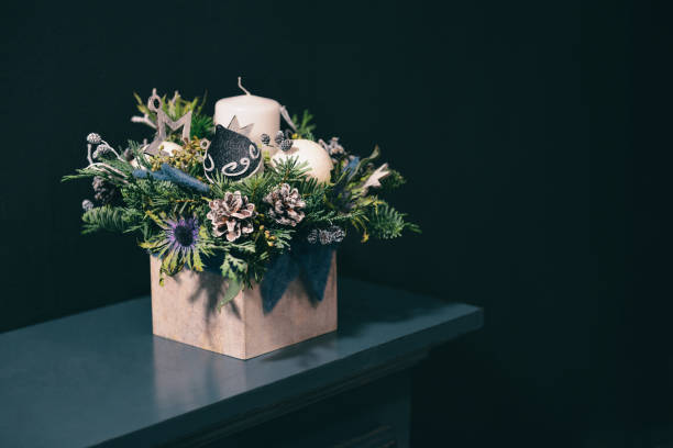 Christmas floral composition. a New Year's bouquet with candles. in dark tones background