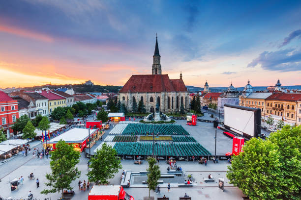 Cluj, Romania. Cluj, Romania: 2 June, 2018 - Medieval St. Michael's Church and Union Square at sunset during Transilvania International Film Festival (TIFF). toronto international film festival stock pictures, royalty-free photos & images