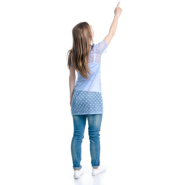 istock Woman in blue jeans standing pointing showing 1139316672