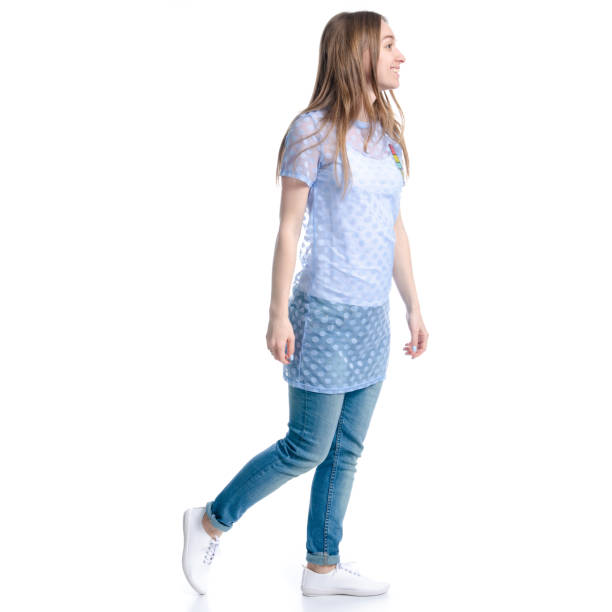 istock Woman in blue jeans walking goes smiling looking 1139316675