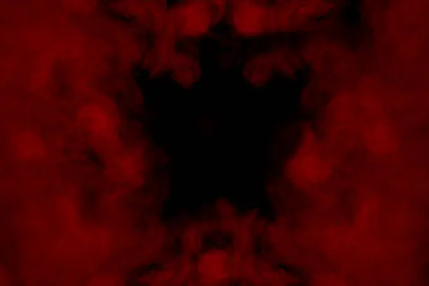 Photo of charming dark pattern formed by a red mystical cloud of cigarette vapor
