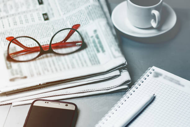 istock Desktop, office worker. News newspaper, glasses, notepad, modern mobile phone. 1139323125