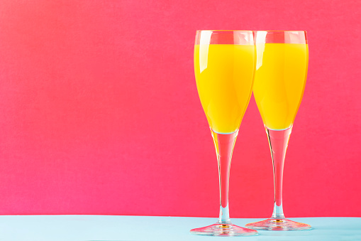 Festive alcohol cocktail mimosa with orange juice and cold dry champagne or sparkling wine in glasses