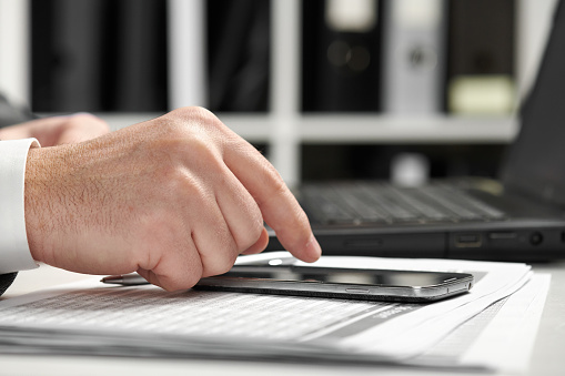 Businessman working in an office. Hands closeup.