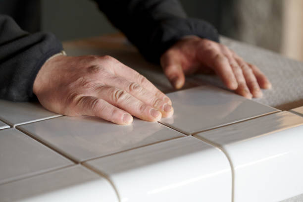 istock Man Tiling New Shop Counter With Unusual Ceramic Tile 1139324410