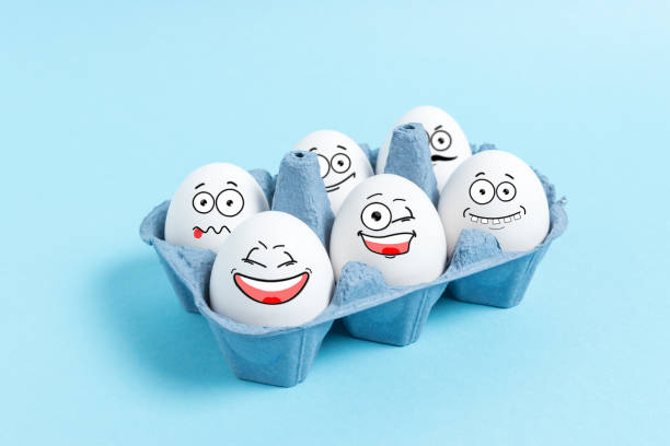 istock Easter eggs with funny face in carton tray on blue background. Minimal concept. 1139324873