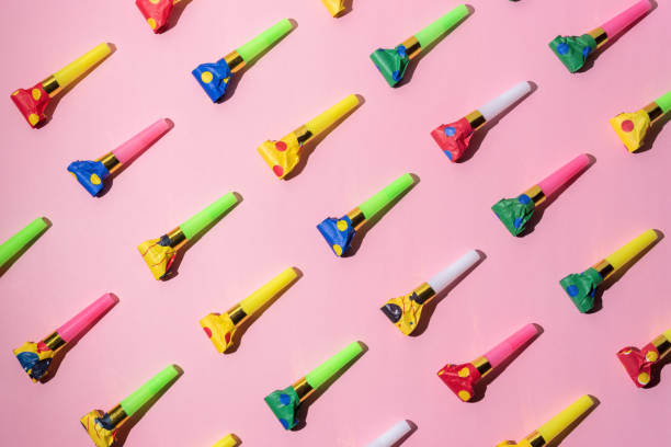 istock Colorful celebration pattern with party blower horns. Minimal party concept. Flat lay. 1139324929