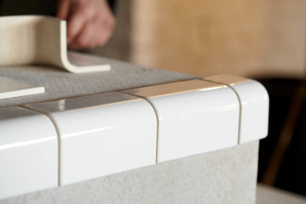 istock Man Tiling New Shop Counter With Unusual Ceramic Tile 1139326655