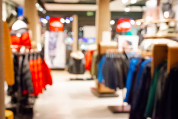 Blurred, defocused background of modern clothing store, abstract blurred fashion men shop background