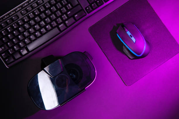 istock Top view a gaming gear, mouse, keyboard, joystick, headset, VR Headset on black table background. 1139326769