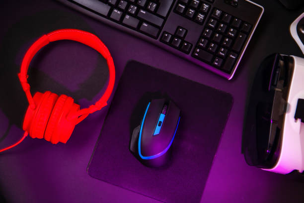 istock Top view a gaming gear, mouse, keyboard, joystick, headset, VR Headset on black table background. 1139326834