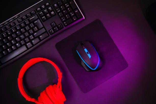 istock Top view a gaming gear, mouse, keyboard, joystick, headset, VR Headset on black table background. 1139326874
