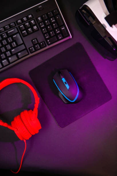 istock Top view a gaming gear, mouse, keyboard, joystick, headset, VR Headset on black table background. 1139327063