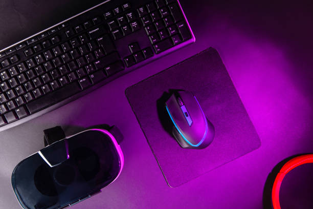 istock Top view a gaming gear, mouse, keyboard, joystick, headset, VR Headset on black table background. 1139327115