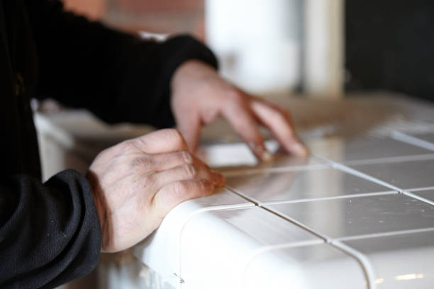 istock Man Tiling New Shop Counter With Unusual Ceramic Tile 1139327845