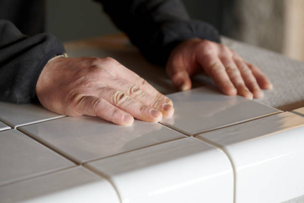 istock Man Tiling New Shop Counter With Unusual Ceramic Tile 1139327990