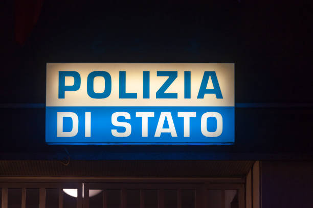 Genoa, Italy - March 30 2019: Illuminated sign above the entrance door of a police station stating \