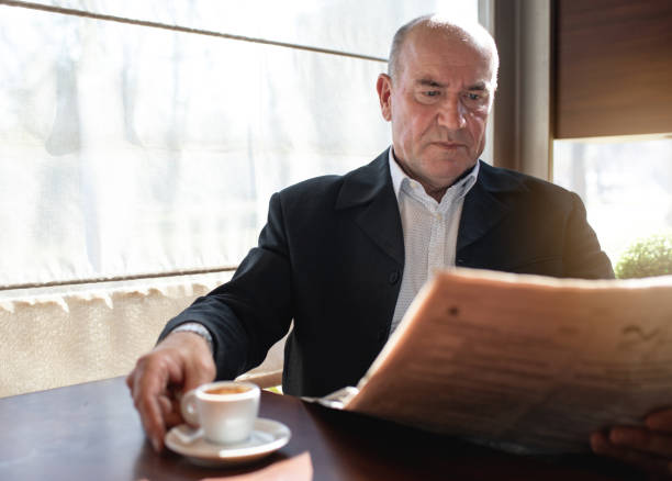 istock Serious senior businessman drinking coffee while reading newspapers 1139331728