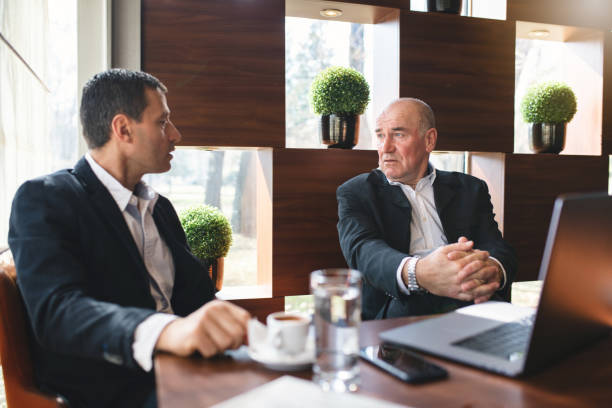 istock Businessmen having a meeting at a cafe 1139333999