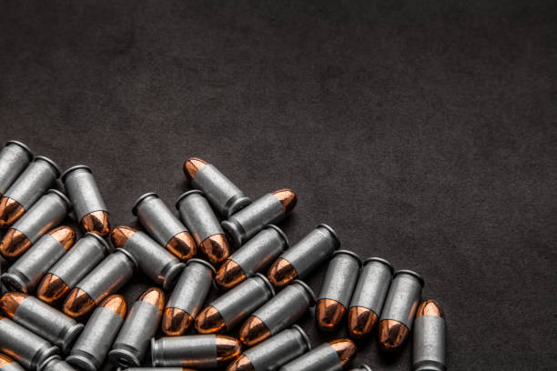 istock cartridges for a pistol on a black background. Flat lay copyspace 1139334085