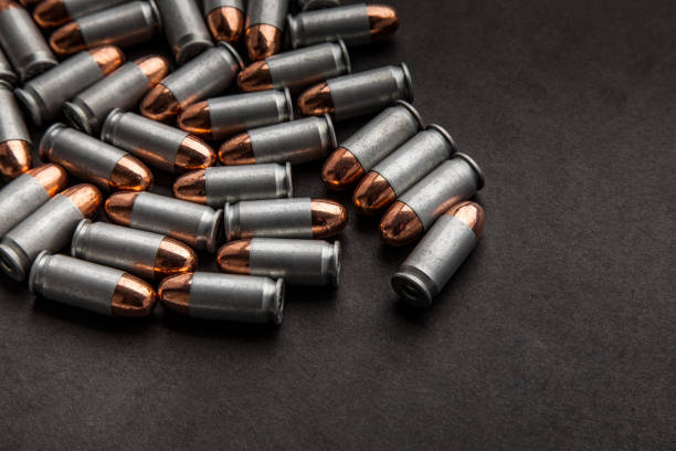 istock cartridges for a pistol on a black background. Flat lay copyspace 1139334099