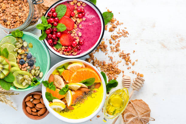 istock A healthy breakfast. Colorful fruit smoothies with yogurt, fresh fruit and berries. Top view. Free space for your text. On a white background. 1139335769