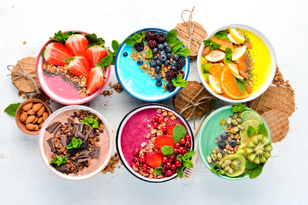 istock A healthy breakfast. Colorful fruit smoothies with yogurt, fresh fruit and berries. Top view. Free space for your text. On a white background. 1139338567