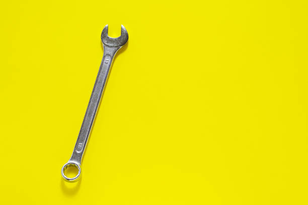 istock Spanner key on yellow  background. Screw driver set.  Background for your text and design. 1139342249