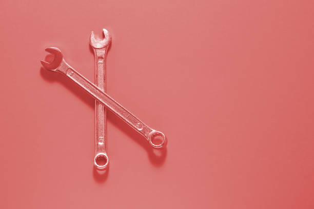 istock Two Spanner keys on Living coral  background. Screw driver set. Wrench spanners. Background for your text and design. 1139342595