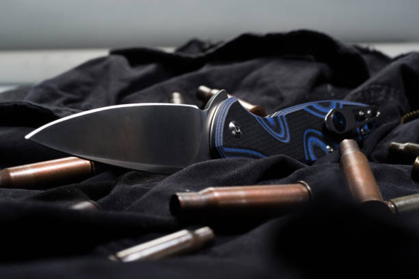 istock Scattered ammunition on a black background. Cartridges and knife. 1139343965