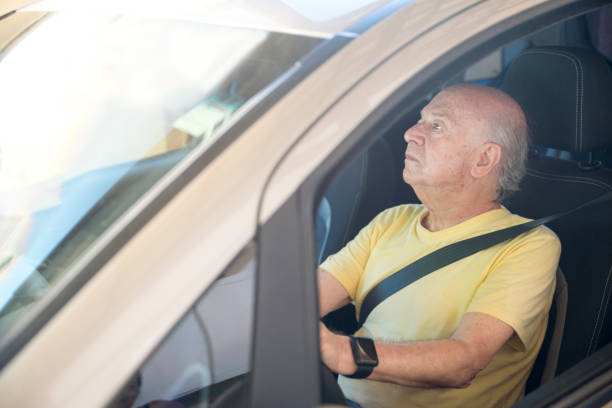 istock Senior man driving a car looking at mirror 1139344394