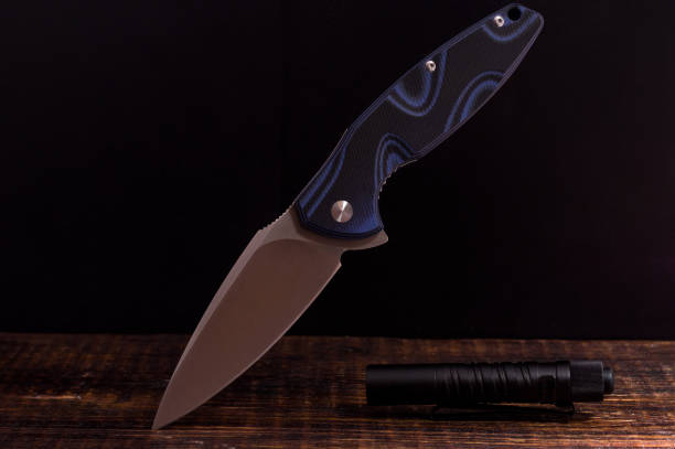 istock Pocket knife and flashlight. Knife in a suspended position. 1139344497