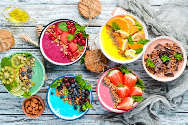 istock A healthy breakfast. Colorful fruit smoothies with yogurt, fresh fruit and berries. Top view. Free space for your text. On a white background. 1139344528