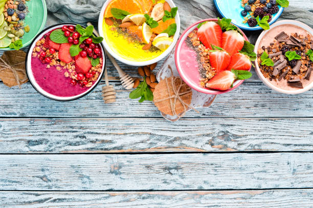 istock A healthy breakfast. Colorful fruit smoothies with yogurt, fresh fruit and berries. Top view. Free space for your text. On a white background. 1139344540