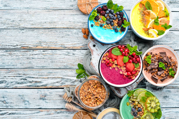 istock A healthy breakfast. Colorful fruit smoothies with yogurt, fresh fruit and berries. Top view. Free space for your text. On a white background. 1139344583