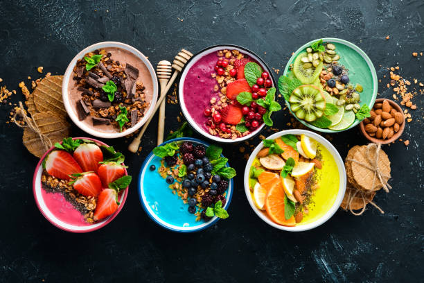 istock A great set of colored fruit smoothies with yogurt, fresh fruit and berries. A healthy breakfast. Top view. Free space for your text. On a black background. 1139344607