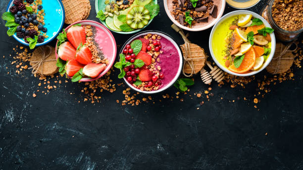 istock A great set of colored fruit smoothies with yogurt, fresh fruit and berries. A healthy breakfast. Top view. Free space for your text. On a black background. 1139344616