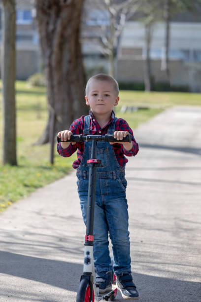 istock little boy play balance scooter 1139345608
