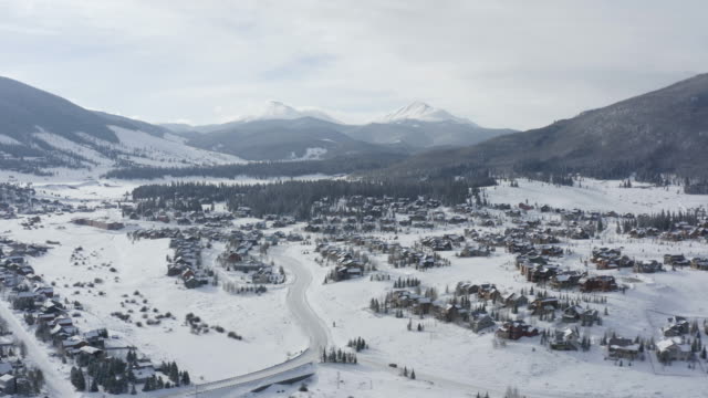 Colorado Mountain Town Summit County Aerial Flyover Winter Snowy Day Two Peaks