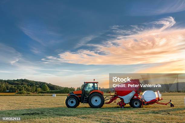 Tractor With Silage Bale Machine Stock Photo - Download Image Now - Tractor, Bale, Agricultural Machinery