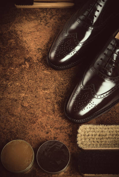 shoes care product concept still life, vintage style composition with shoe care products on a vintage wood and rustic background, vintage style shoe polish photos stock pictures, royalty-free photos & images