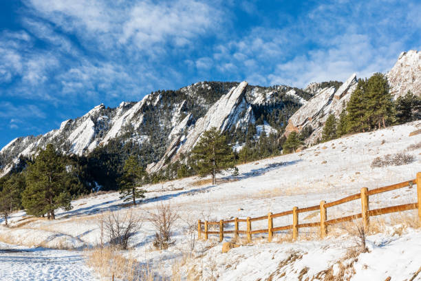 Chautauqua Park Fence and Powder Covered Flatirons A fresh coating of snow coats the Flations rock formations, seen from Chautauqua Park in Boulder, Colorado table ledge stock pictures, royalty-free photos & images