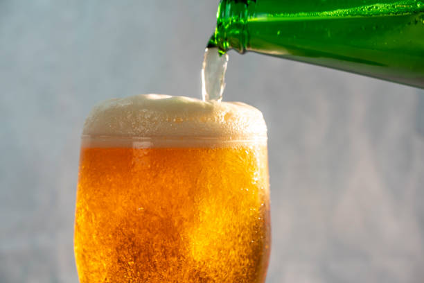 istock pouring beer into a glass from a bottle 1139355566